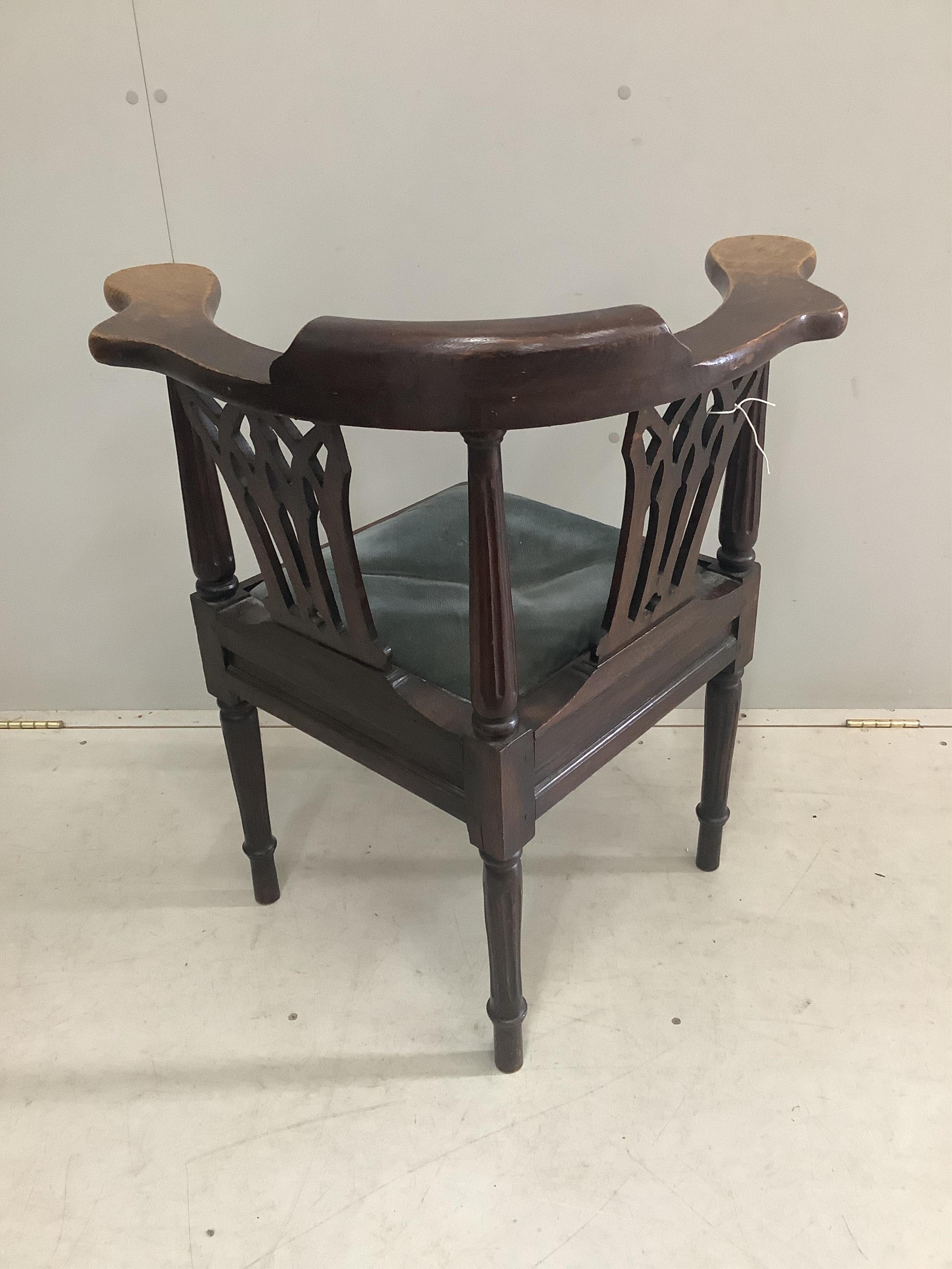 A George III oak corner elbow chair, width 72cm, depth 60cm, height 81cm